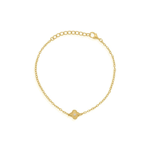 Gold bracelet with a small clover element on a white background