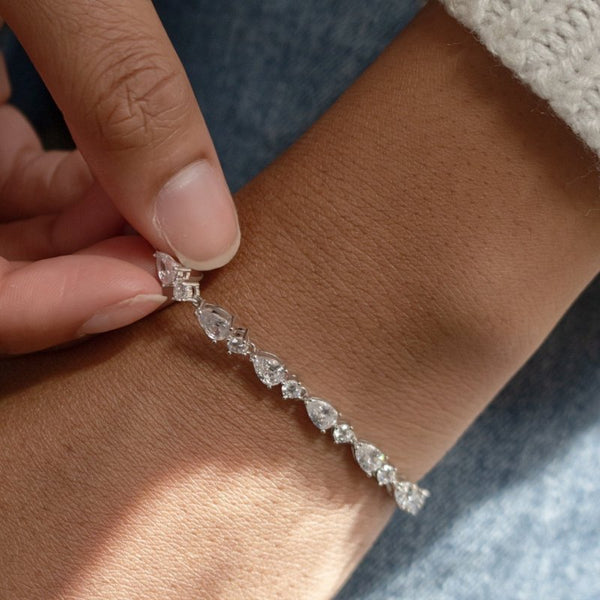 Diamond bracelet being worn on a wrist with a blurred background
