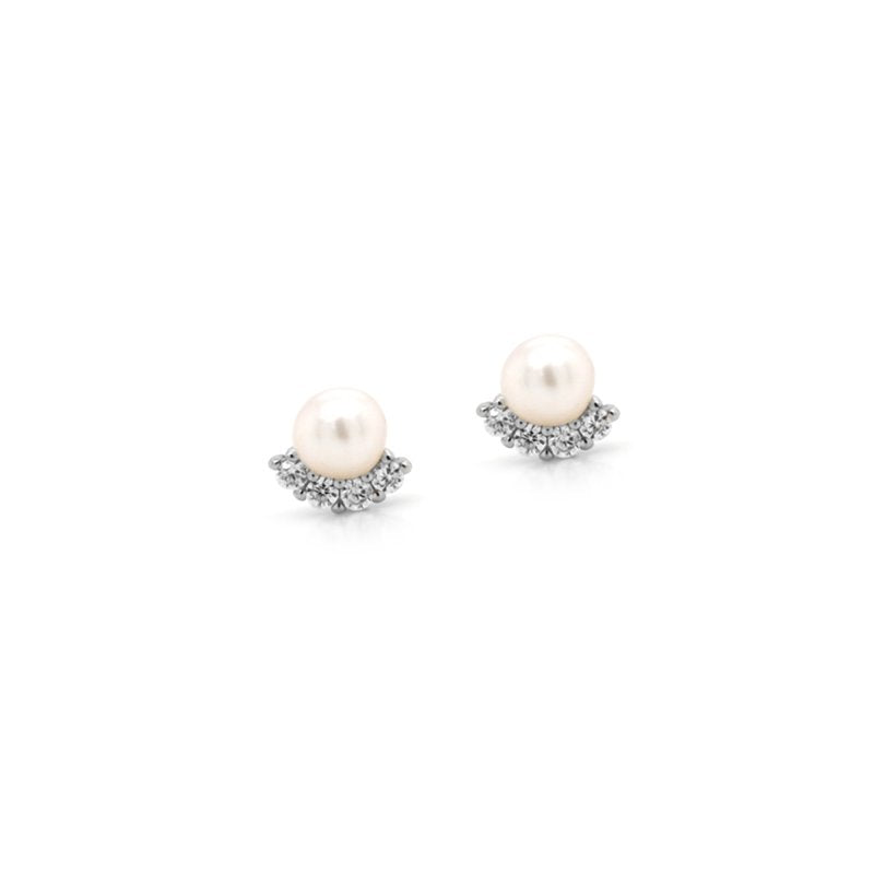 Pair of pearl earrings with silver accents on a white background