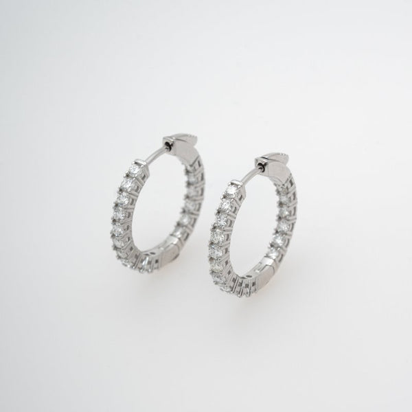 Silver hoop earrings with 1.5ct diamonds on a white background