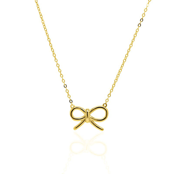 Gold bow-shaped pendant on a chain against a white background