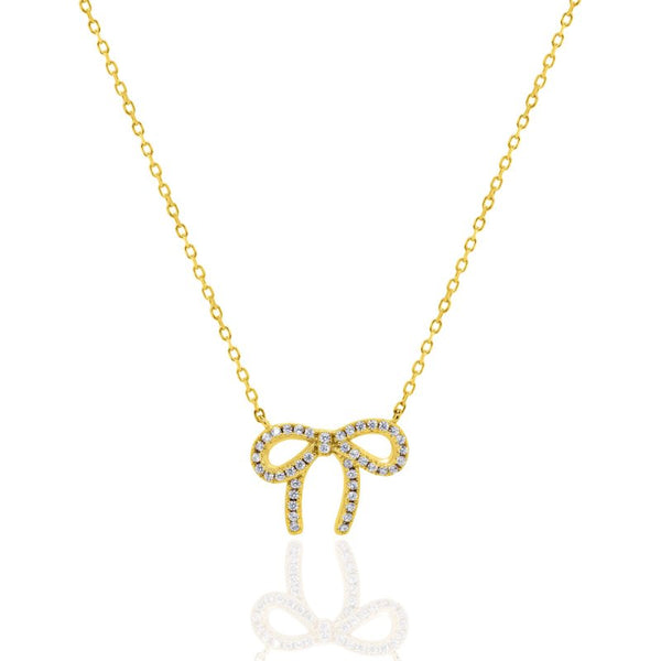 Gold bow-shaped necklace with diamonds on a white background
