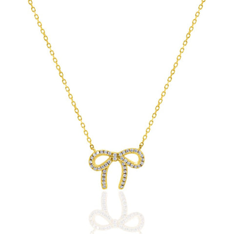 Gold bow-shaped necklace with diamonds on a white background