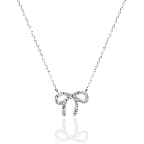 Silver bow-shaped pendant necklace on a white background