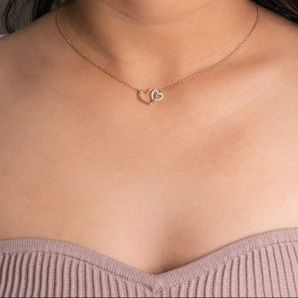 Necklace with a heart pendant worn by a person