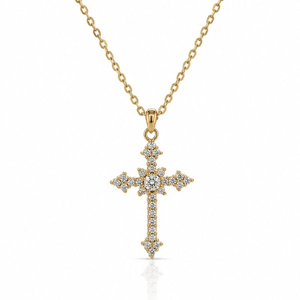 A gold cross pendant necklace adorned with small clear stones, suspended from a delicate gold chain against a clean white background.