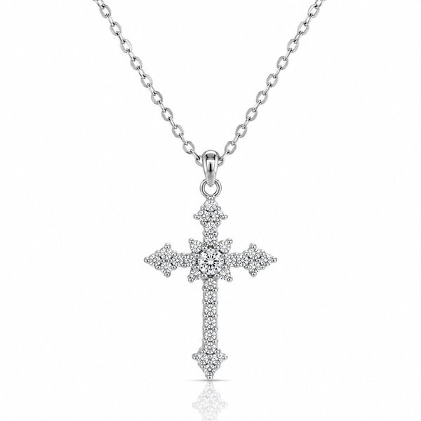 A silver cross pendant necklace paved with small clear stones, hanging from a delicate silver chain against a white background.